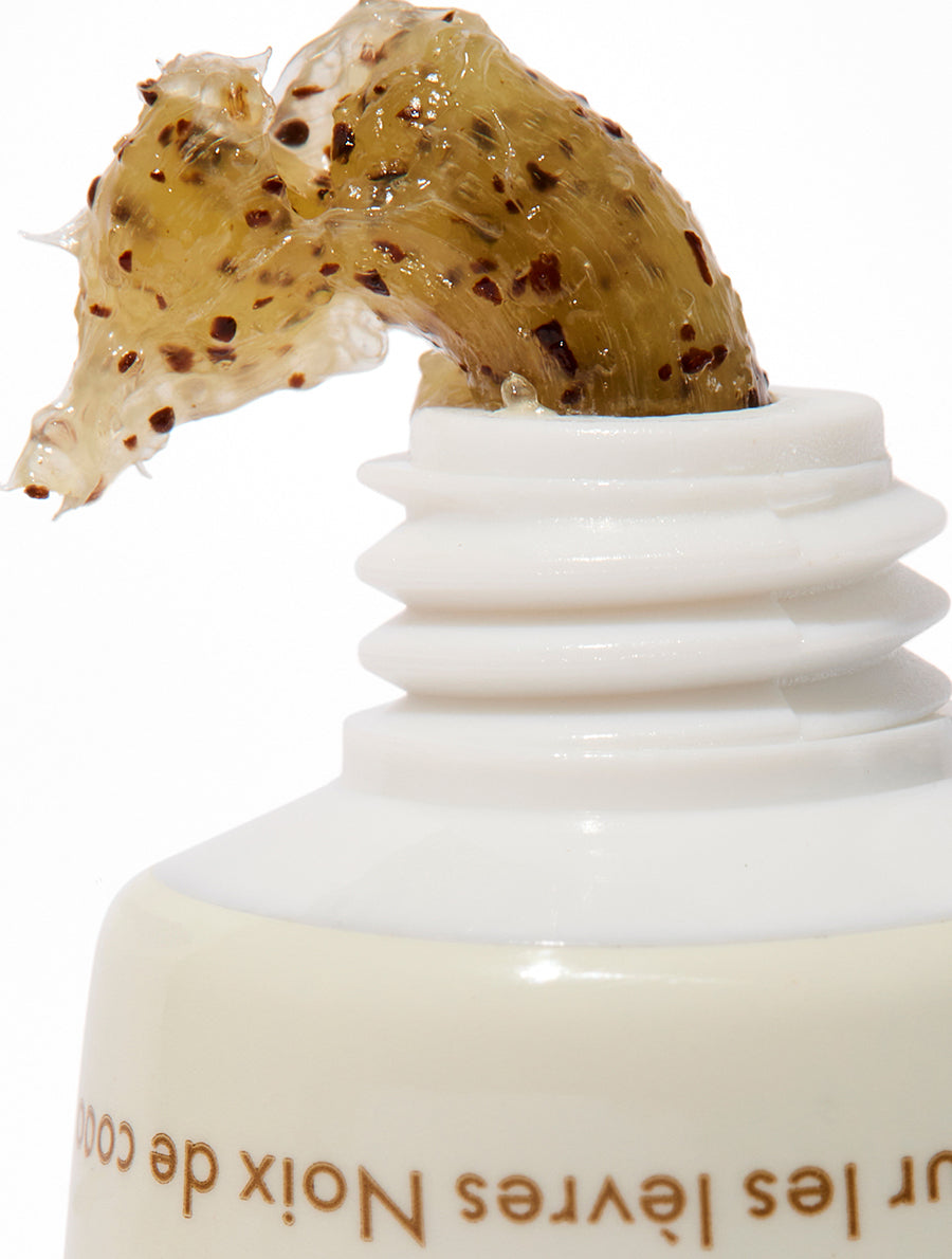 Close up texture shot of the Lanolips Lip Scrub Coconutter. Made with gentle sugar and real coconut shell pieces to smooth away dead skin, while the 70% lanolin deeply hydrates.