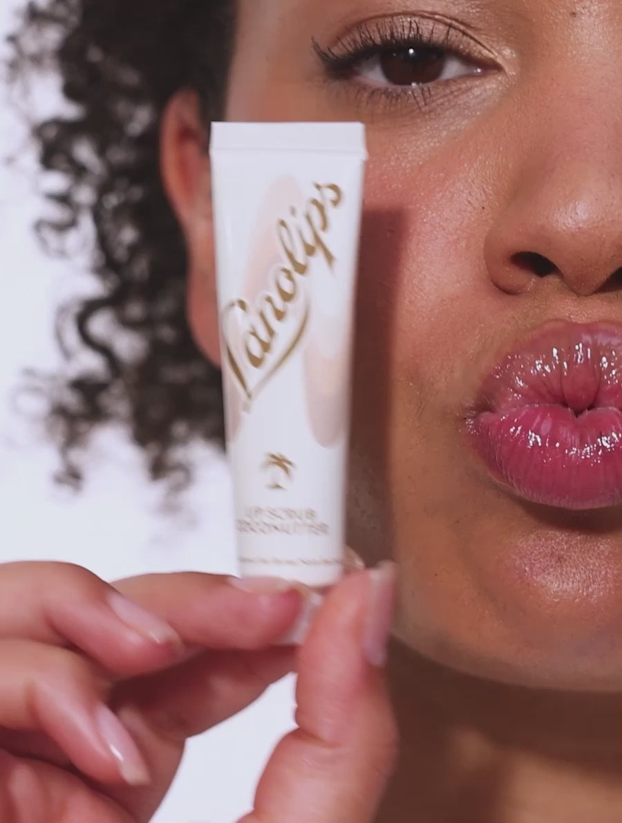 Video showcasing Lanolips Lip Scrubs in Coconutter and Strawberry. These 100% natural balm-based lip scrubs use gentle sugar and finely ground fruit to exfoliate dry lips. With 70% lanolin, they deeply hydrate and reveal soft, smooth lips with a healthy glow.