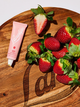 Load image into Gallery viewer, Our Lanolips 101 Ointment Multi-Balm in Strawberry has real strawberry fruit extracts. Strawberries are packed with vitamin C, which is known to even out skin tone. We love it&#39;s natural sweetness &amp; good vibes
