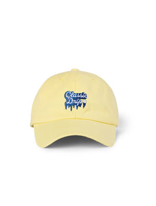 Lanolips Classic Drip Yellow Cap front view. Made with 100% cotton, and the Classic Drip embroidered slogan at the front. 