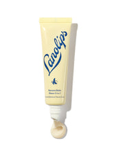 Load image into Gallery viewer, Lanolips Banana Balm Sheen 3-in-1 in a soft yellow squeezable tube with a white cap. The packaging features the Lanolips logo in bold blue lettering and a small banana icon, highlighting its creamy, nourishing formula. A swirl of the balm is visible at the opening, showcasing its rich texture and subtle pearlescent sheen. This hydrating lip balm is infused with lanolin and banana extract, designed to soften, condition, and add a natural glow to dry lips.

