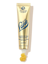 Load image into Gallery viewer, Lanolips Golden Dry Skin Miracle Salve in a metallic gold squeezable tube with a white cap. The packaging features the Lano logo in deep blue lettering, along with ‘Made with Love and Lanolin’ inscribed at the top. A small amount of the rich, golden balm is shown oozing from the tube, emphasising its ultra-hydrating, multi-purpose formula designed to deeply nourish and repair very dry skin, hands, and rough patches.
