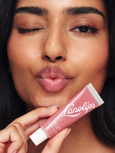 Load image into Gallery viewer, Model wearing and winking Lanolips Tinted Lip Balm SPF 30 in Rhubarb
