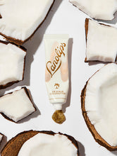 Load image into Gallery viewer, Squeezed tube of Lanolips Lip Scrub Coconutter. A 100% natural balm base scrub made with gentle sugar and real, finely ground coconut shell pieces to smooth away dead skin.
