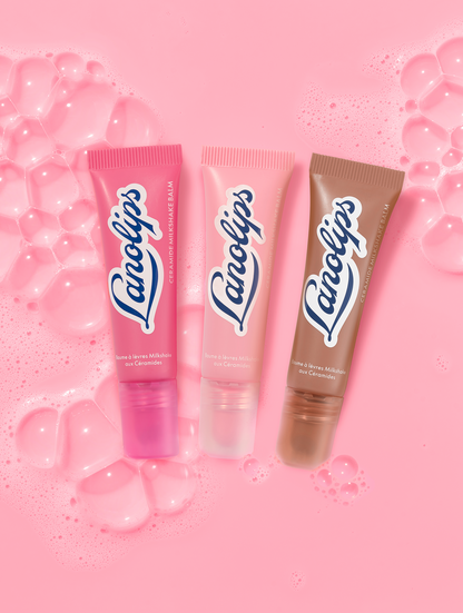 Lanolips ceramide milkshake mini balms lip balm tubes in pink and brown packaging on a pink bubble background.