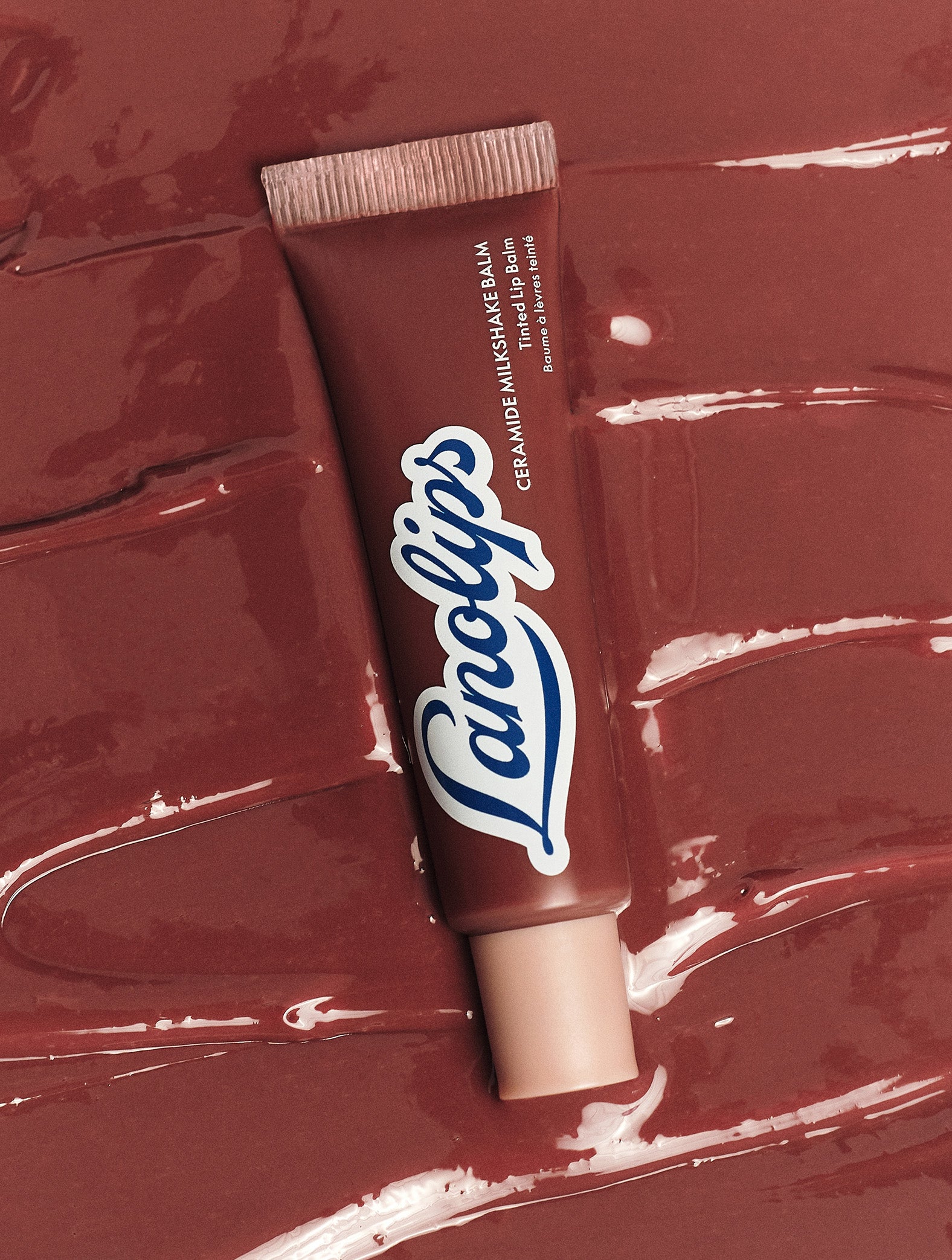 Lanolips Ceramide Milkshake Balm in Caramel Melt on glossy balm texture, a rosy-caramel nude tint made with 90% lanolin, boosted with ceramides and murumuru butter to strengthen the lip barrier