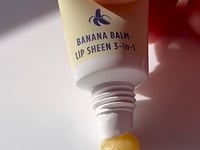 Load and play video in Gallery viewer, Banana Balm Lip Sheen 3-in-1 is a lip protectant, lip sheen and a lip lustre sheen, with banana extract for a hit of happy!

