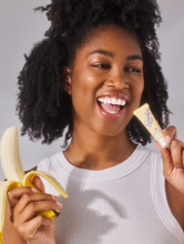 Load image into Gallery viewer, Model wearing Lanolips Banana Balm Lip Sheen 3-in-1, a whipped banana &amp; lanolin lip sheen, for juicy, glowing lips.
