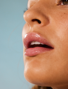 Model wearing Lemonaid Lip Treatment, with lemon oil to naturally exfoliate, leaving lips fresh, soft & moist.